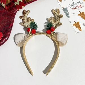Detail of Christmas reindeer antler headband with sequins, red pom-poms and tiny bells
