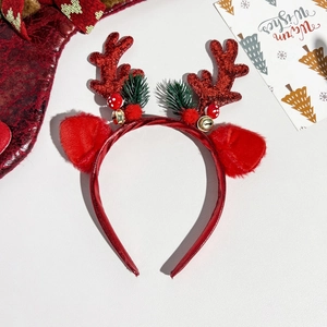 Detail of red sequined reindeer antlers headband with festive ornaments and bells