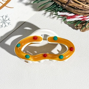 Detail of Christmas wave hair claw clip with colorful dots and strong festive props