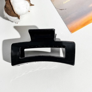 Macro shot of 8.5cm glossy black rectangular hair claw clip with cutout geometry design