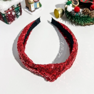 Nahaufnahme des roten Pailletten-Weihnachtshaarreifs mit Knoten und festlichem Dekor