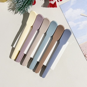 Detailed view of the 6-piece plastic spatula set in various earthy pastel colors on white