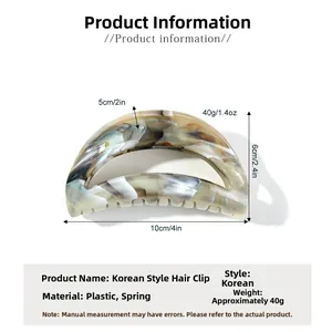 Detailed view of the 10cm large marble patterned shark hair claw with metal spring