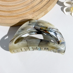 Detailed macro view of the marble pattern texture on this semi-circular shark hair claw clip