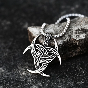 Vintage stainless steel Triple Horn of Odin pendant with Celtic knot on dark rock