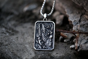 Macro shot of vintage stainless steel tag pendant with detailed relief and metal chain