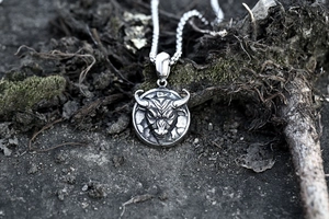 Macro shot of retro stainless steel bull head pendant with intricate vintage relief details