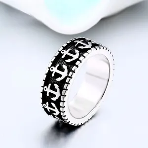 Detailed macro view of retro nautical men's ring with silver anchor relief patterns