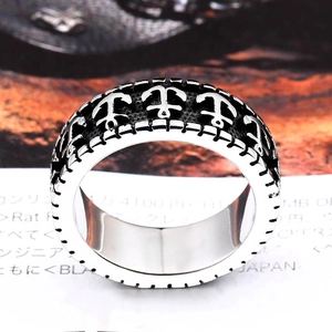 Macro close-up of retro stainless steel men's ring with embossed anchor design pattern