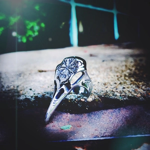 Macro view of Viking raven skull ring featuring Vegvisir symbol on a stone base