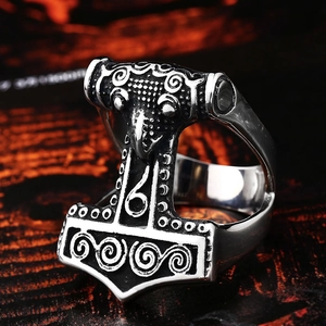 Macro shot of vintage silver Mjolnir Viking ring with detailed Celtic relief on steel