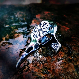Detailed view of Viking raven skull ring with engraved Vegvisir compass on retro steel