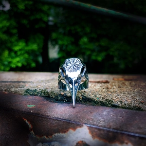 Macro shot of Viking raven skull ring featuring Vegvisir compass and Nordic runes detail