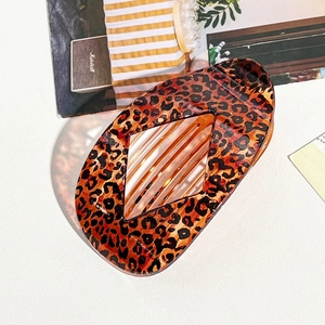 Leopard print oval claw clip with diamond cutout design for elegant hairstyling