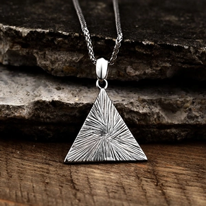 Polished stainless steel Eye of Egypt triangle pendant with wheat chain on dark stones