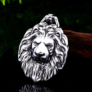 Detailed vintage lion head pendant in stainless steel for men on a dark wood block