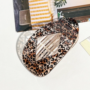 Leopard print hair claw clip with acetate texture and oval geometric hollow design