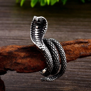 Macro shot of cobra snake ring showing detailed scales and vintage oxidation on steel