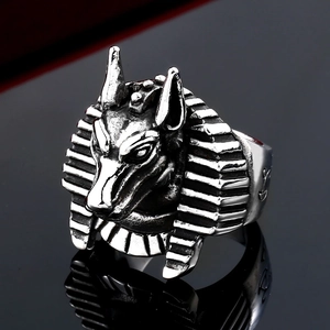 Macro detail of vintage stainless steel Anubis wolf head ring with mystical engravings