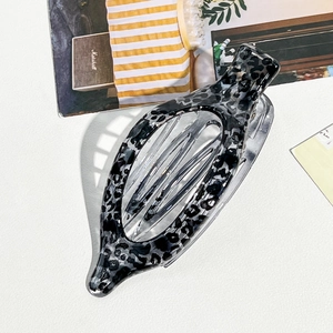 Curved leopard print hair claw clip in white and grey colors with glossy finish