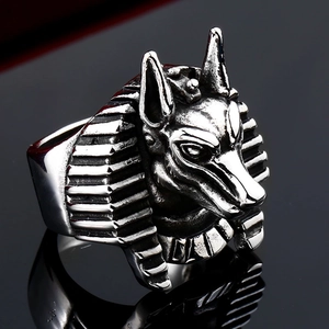 Macro detail of vintage stainless steel Anubis ring with wolf head design on black background