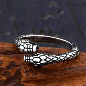 Macro detail of the double-headed snake ring with intricate textured scales in retro steel