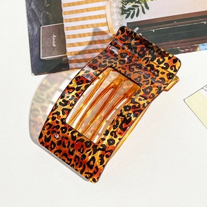 Chic amber leopard print hair claw clip in a modern rectangular geometric design
