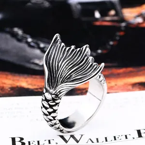 Macro detail of retro mermaid tail ring showing intricate fish scale texture and silver finish