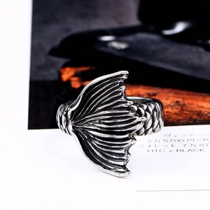 Detailed macro shot of vintage fish scale textures and mermaid tail design on a silver ring