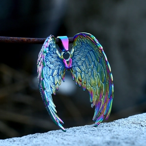Macro shot of iridescent angel wings pendant with detailed feather texture in rainbow colors