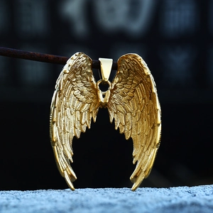 Close-up of golden stainless steel angel wings pendant showing detailed feather textures