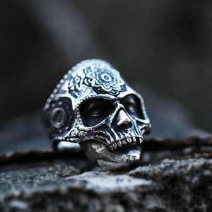 Macro shot of vintage stainless steel skull ring with intricate mandala floral carvings
