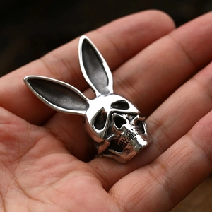 Macro shot of vintage stainless steel skull ring with long rabbit ears on hand