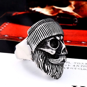 Vintage stainless steel skull ring with beanie and thick beard in gothic punk style