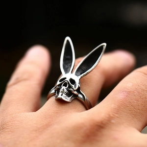 Detailed close-up of a vintage silver skull ring with bunny ears in gothic punk style