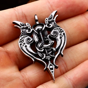 Detailed macro shot of vintage stainless steel double raven and sword pendant