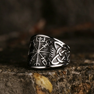 Retro Viking Vegvisir ring in stainless steel resting on a textured dark rock