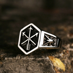 Retro stainless steel signet ring for men featuring cross arrow relief on a grey rock background