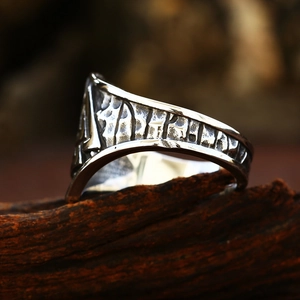 Macro shot of Viking runes engraved on a vintage style men's stainless steel band ring
