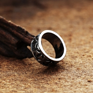 Vintage stainless steel cross ring with black oxidized finish shown on wood display