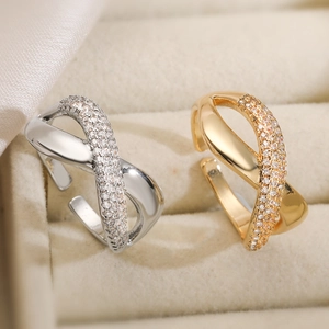 Crossed geometric open rings in gold and silver finish with zircon stone pavé setting