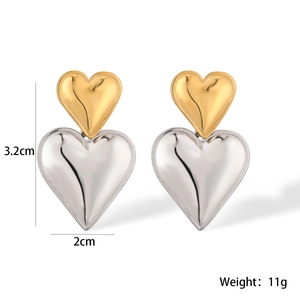 Detail showing heart-shaped mixed metal earrings with 3.2cm height and 2cm width