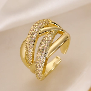 Close-up of gold-plated geometric ring featuring layered cubic zirconia and polished bands