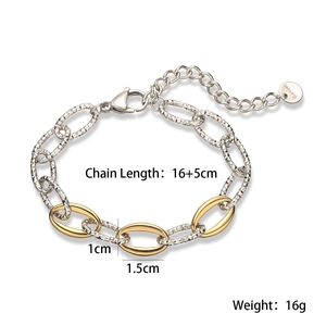 Macro shot of 18K gold and silver two-tone stainless steel chain links with lobster clasp