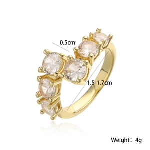 Elegant gold geometric V-shaped ring with five round cubic zirconia stones on white background