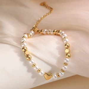 Elegante bracciale di perle con ciondolo a cuore dorato e chiusura regolabile