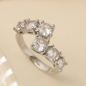 Silver geometric open ring with shimmering round cubic zirconia in a wave layout