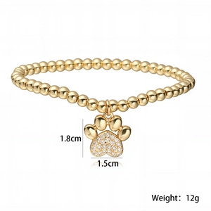 Detail van 18K vergulde kralenarmband met zirkonia poot-hanger en afmetingen in beeld