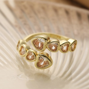 Gold plated open ring featuring heart-shaped champagne zircon gemstones in a luxury design