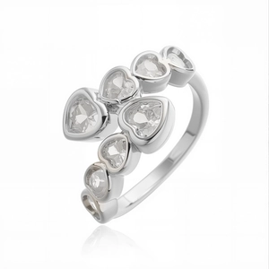 Macro shot of silver ring featuring clustered heart-cut cubic zirconia in a modern style
